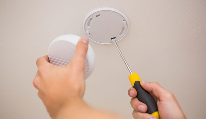 Handyman Installing Smoke Detector Systems